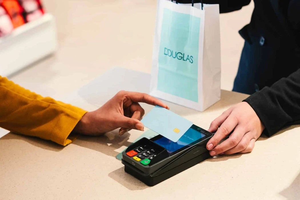 PAX A35 Android PIN pad in use at a retail checkout with a customer making a payment.